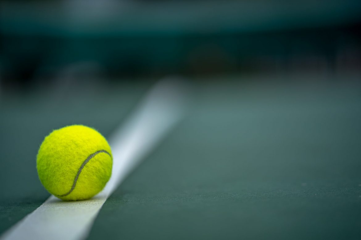beginning-champion-close-up-tennis-ball-courts-background-scaled.jpg